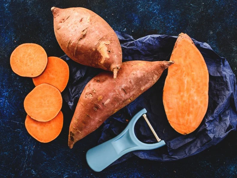 Sliced and whole sweet potatoes
