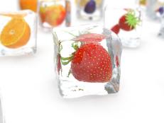 Strawberry in ice cube isolated on white with depth of field effects. Ice cubes with fresh berries. Berries fruits frozen in ice cubes. 3D rendering