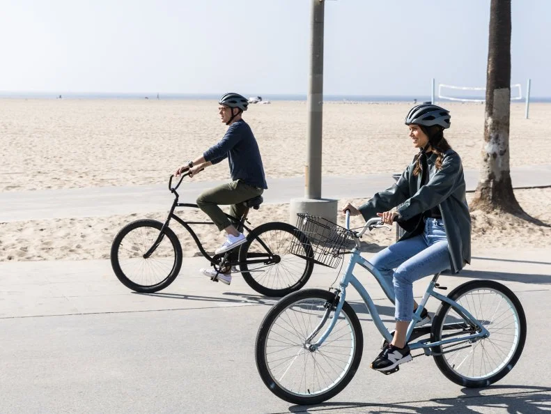 Host Bobby and Sophie Flay ride bikes in Venice, CA, as seen on Bobby and Sophie Take the Coast, Season 1.