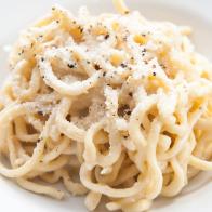 Tonnarelli cacio e pepe is a typical Lazio specialty, Italy, spaghetti with pecorino cheese and pepper  on white background