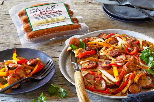 Trader Joe's Unexpected Cheddar Chicken Sausage prepared as pan-fried slices with strips of onoin and bell peppers
