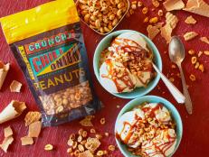 Trader Joe's Crunchy Chili Onion Peanuts used as topping over french vanilla ice cream and Fluer de Sel Caramel Sauce; broken bits of sugar cone surround bowls