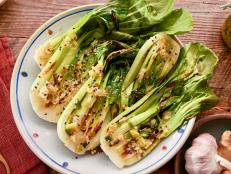 Beauty shot of Molly Yeh's Grilled Bok Choy with Ginger Scallion Garlic Oil as seen on Girl Meets Farm, Season 11.