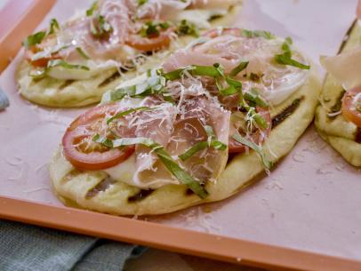 Beauty shot of Molly Yeh's Margherita and Prosciutto Pizzettes as seen on Girl Meets Farm, Season 11.