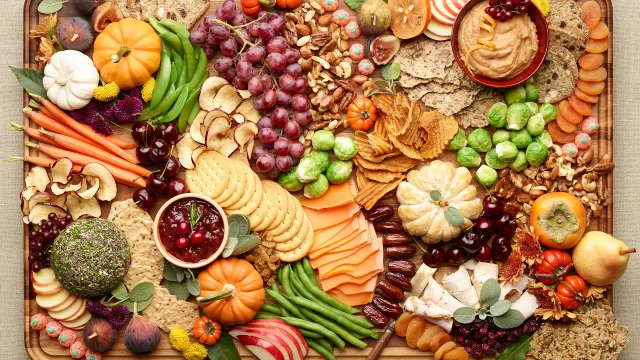 Festive Thanksgiving charcuterie board with cheeses, meats, fruits, and nuts
