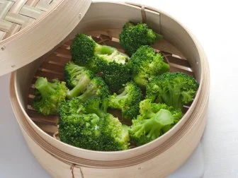 Brocolli florets steamed in a bamboo steamer.