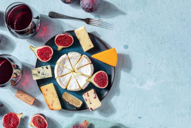 Cheese banner. A variety of cheeses on a plate, shot from the top with a place for text, a flat lay