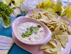 Molly&rsquo;s daughter Bernie loves cheese, so she had to make her a pool of queso as an appetizer for her birthday. This recipe is extra delicious with the addition of tangy yogurt that cuts the richness of the cheese and keeps you dipping back for more!