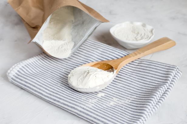 Crumbly xanthan gum in a wooden spoon. Natural thickening agent used in cooking.