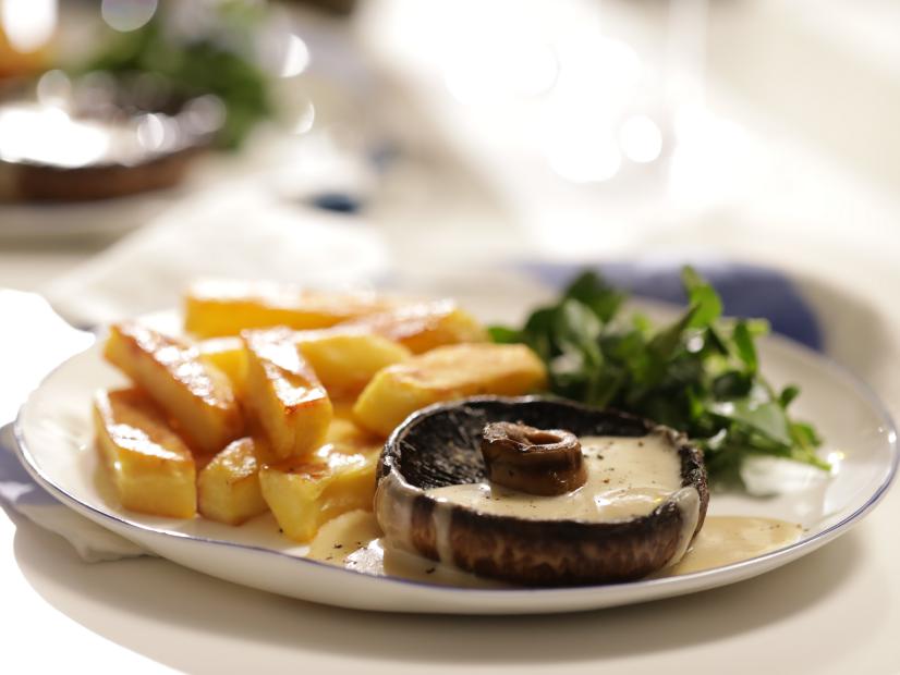Landscape, close-up of muchroom steak on table with chips, as seen on Mary McCartney Serves It Up, season 3.