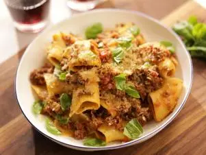 Close-up, above shot, bowl of pasta bolognese on wooden board, as seen on Mary McCartney Serves It Up, season 3.