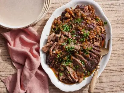 Description: Food Network Kitchen's Instant Pot Holiday Brisket. Keywords: Beef Brisket, Red Wine, Garlic, Onions, Bay Leaves, Hoisin, Thyme