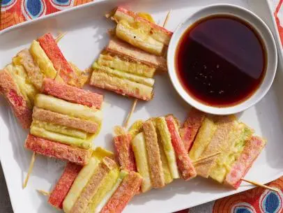 Description: Food Network Kitchen's Ohsek Kkochi Jeon (Sanjeok). Keywords: Tteok, Korean Rice Cakes, Imitation Crab Sticks, Scallions, Danmuji, Korean Smoked Fish Ham, Soy Sauce, Gochugaru