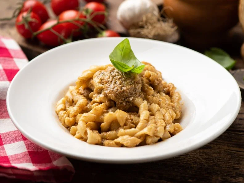 Busiate Pasta with red pesto sauce, pesto Trapanese. Close up