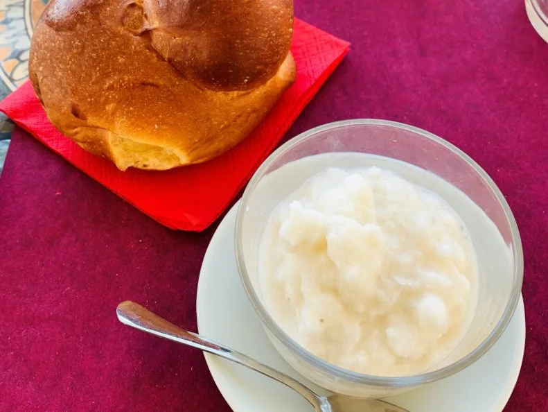 A typical Sicilian breakfast with almond granita and brioche, in a cafe in Noto, Sicily