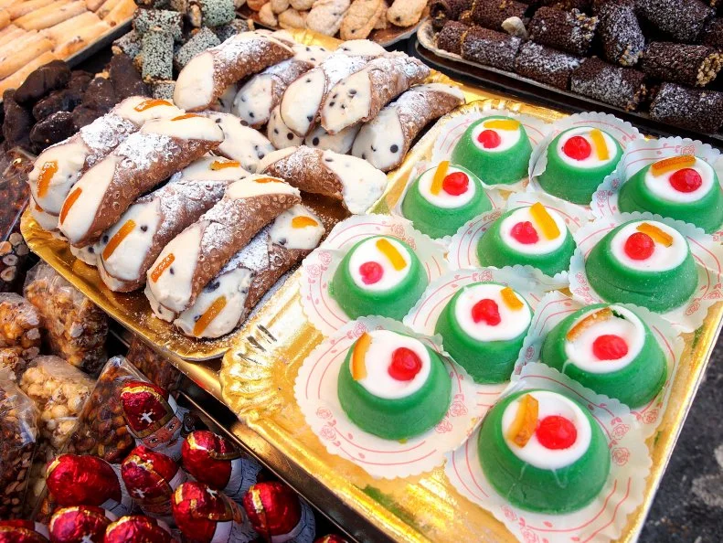 Sicilian food: cannoli and cassate on sale in a street food market.