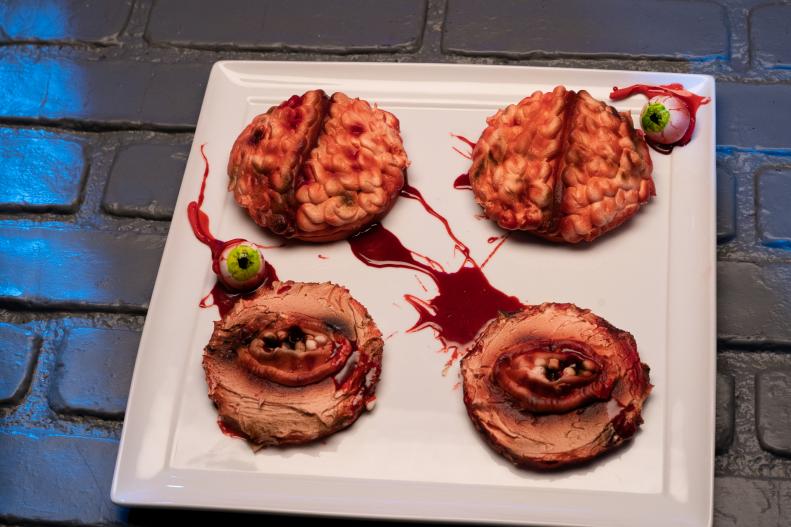 Contestant Minh Bingham's round 1 dish, a brain and a mouth, Sour green apple caramel cookie and a tart buttercream, as seen on Halloween Cookie Challenge, Season 1.