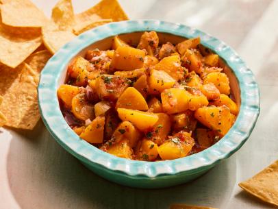 Description: Ree Drummond's Peach Salsa. Keywords: Garlic, Red Onions, Jalapenos, Bell Peppers, Chili Powder, Limes, Peaches, Cilantro.