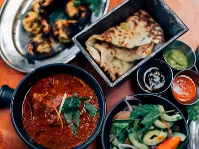 Butter chicken curry, grilled prawns and nan bread.