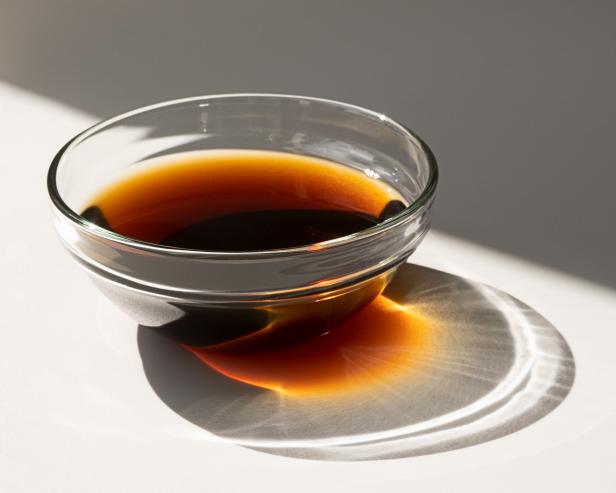 soy sauce in a glass cup. beautiful shadow from the gravy boat
