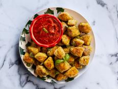 Ree&rsquo;s mom used to make mystery rolls back in the 1970s. The original recipe used butter, garlic powder and blue cheese, but Ree has given the dish a more contemporary feel by adding fresh garlic, pesto and Parmesan to the butter.