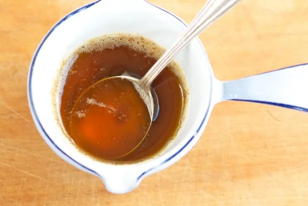 Browned butter sauce with a silver spoon from above