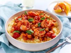 This one-skillet dish made with harissa shrimp and chickpeas takes under 30 minutes to make! Served with lemon couscous, you'll love how hearty and easy to make this dish is.