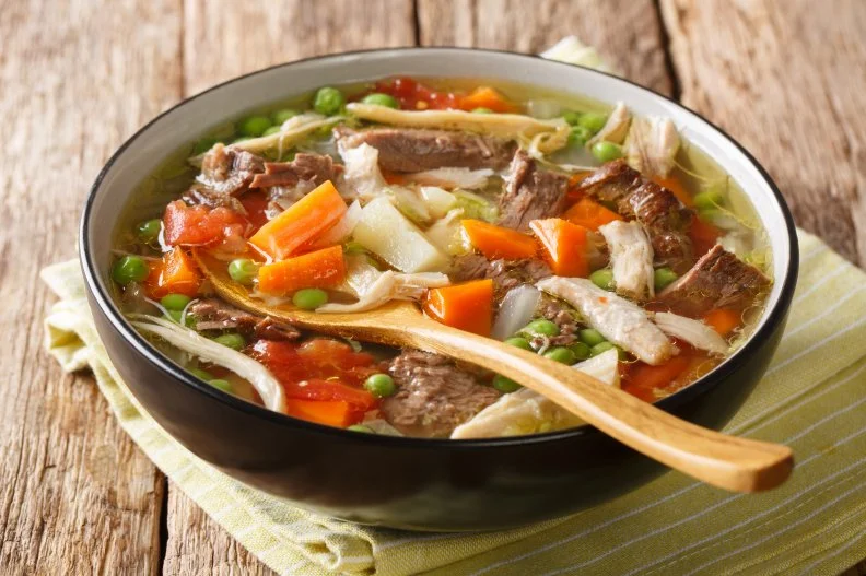 Homemade authentic Booyah slowly stew with vegetables close-up in a plate on the table. horizontal