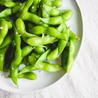 Just cooked bright, fresh and green edamame with sprinkled salt.  Shot using natural light