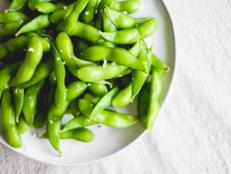 Just cooked bright, fresh and green edamame with sprinkled salt.  Shot using natural light