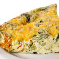 Breakfast vegetable and cheese egg frittata on white background