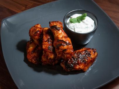 Anne Burrell’s Indian-Inspired Grilled Chicken Wings with Spiced Yogurt Sauce are displayed, as seen on Worst Cooks in America, Season 25.