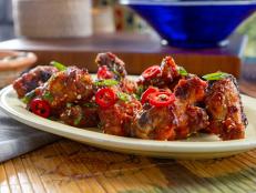 When I think of sweet and sour, it always brings me back to my childhood of eating classic orange chicken. So I thought, why not bake chicken wings and then fry them, and make the bomb pineapple spicy, sweet, and sour sauce? I also wanted to give an extra kick to the dish, so I topped my wings with Fresno chiles for added heat.
