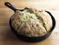 A freshly baked Irish soda bread loaf in a cast iron pan