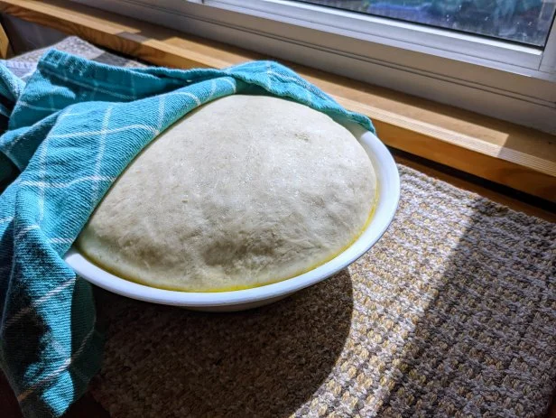 Bowl with rising pizza dough