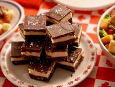 Nanaimo Bars are a Canadian three-layer, no-bake dessert bar with a coconut crumb crust, custard filling and chocolate ganache topping. Molly is upping her ode to Canada and flavoring with sweet maple syrup as well. She thinks they&rsquo;re sweet, custardy, chewy&hellip;and she can&rsquo;t get enough!
