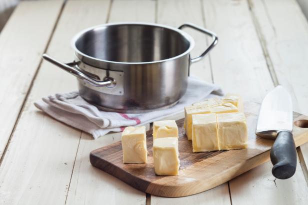 Pieces of butter on cutting board,  for butter ghee, preparation