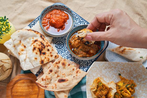 The traditional Indian food, roti served with butter chicken and red curry beef.