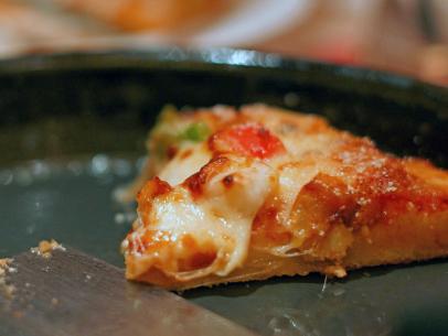 https://food.fnr.sndimg.com/content/dam/images/food/fullset/2023/1/25/reheating-slice-of-pizza-in-skillet.jpg.rend.hgtvcom.406.305.suffix/1674681924385.jpeg