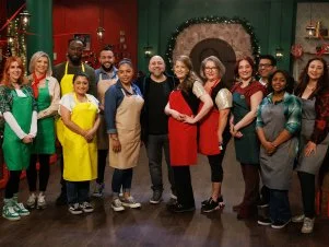 Host Duff Goldman poses with sweet makers Angela Sweetser, Marta Kantorowicz, Blaque Shelton, Cinthya Romriell, Henderson Gonzalez, Oralia Perez, Jolie Skwiercz, Jodi Johnston, Tatiana Kovalenko, Andy De La Cruz, London Johnson and Briea Nathan pose together, as seen on The Elf on the Shelf: Sweet Showdown, Season 1.