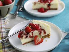 Y'all know I love to make cheesecake, and this strawberry-infused one is Bryon's favorite. I start by making a super easy strawberry jam that is great on its own, but amazing swirled into this New York-style cheesecake. You'll have some left over, so feel free to dollop more on top as garnish and save the rest in the refrigerator for biscuits or toast.