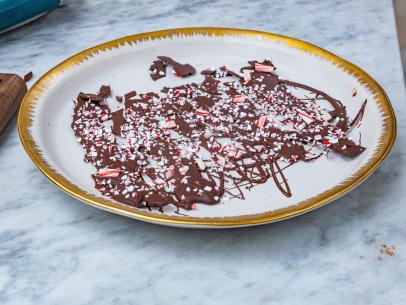 Host Selena Gomez and Chef Alex Guarnascelli's dish "Chocolate Candy Cane Bark", as seen on Selena + Chef: Home for the Holidays, Season 5.