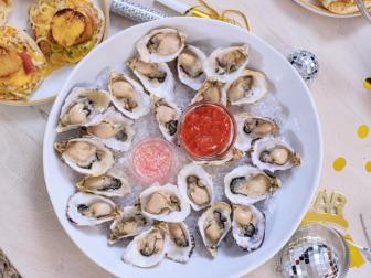 Host Selena Gomez and Chef Eric Adjepong's final dish "Oysters with a champagne mignonette and cocktail sauce", as seen on Selena + Chef: Home for the Holidays, Season 5.
