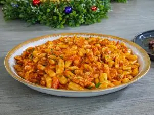 Host Selena Gomez and Chef Michael Symon's complete meal "Reverse Seared Bistecca Florentine w/ Herb Butter, Cavatelli with Spicy Lobster Sauce and
Escarole with Anchovy Garlic Breadcrumbs", as seen on Selena + Chef: Home for the Holidays, Season 5.
