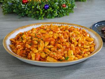 Host Selena Gomez and Chef Michael Symon's complete meal "Reverse Seared Bistecca Florentine w/ Herb Butter, Cavatelli with Spicy Lobster Sauce and
Escarole with Anchovy Garlic Breadcrumbs", as seen on Selena + Chef: Home for the Holidays, Season 5.