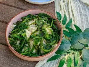 Host Selena Gomez and Chef Claudette Zepeda's dish "Arroz Poblano (side dish of roasted pablano peppers)", as seen on Selena + Chef: Home for the Holidays, Season 5.