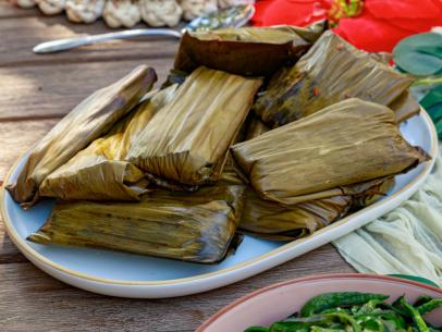 Host Selena Gomez and Chef Claudette Zepeda's dish "Chile Colorado Tamales", as seen on Selena + Chef: Home for the Holidays, Season 5.