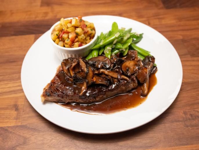 NY Strip Steak with Mushroom Pan Sauce, Crispy Potatoes with Bacon and Snap Peas with Shallots