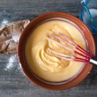 Mixing vanilla pudding with ingredients on rustic table Flat lay