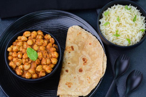 Chana Masala also called as chickpea curry dish served with roti and rice